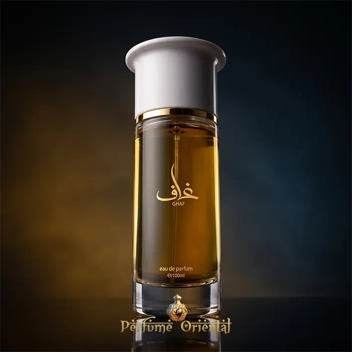 Hero shot of Ghaf Eau de Parfum by Ahmed Al Maghribi, showcasing the elegant clear glass perfume bottle filled with gold liquid and topped with a white cap against a moody, dark background.