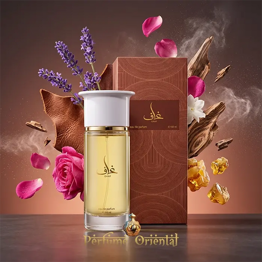 Ghaf oriental perfume by Ahmed Al Maghribi presented next to its matching textured brown packaging box, surrounded by floating fragrance ingredients including lavender, rose petals, and leather